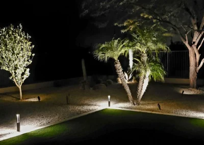 “Scottsdale backyard landscape lighting illuminating trees and the yard, installed by Eclipse Landscape & Design.”