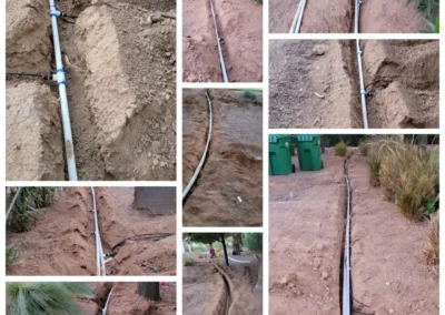 Open trenches with new irrigation pipe in back yard