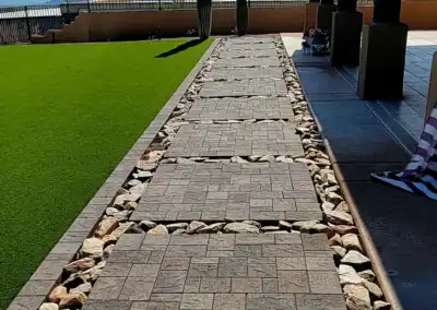 “Scottsdale modern landscape with concrete pavers laid in a precise square pattern, creating a clean contemporary look installed by Eclipse Landscape & Design.”