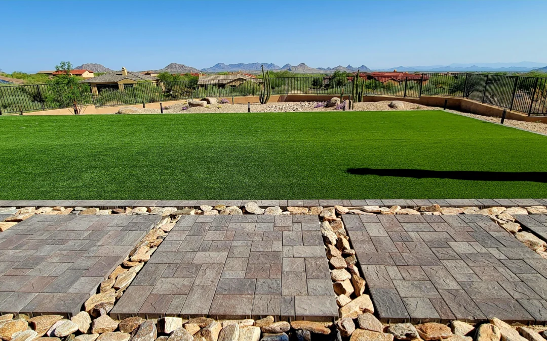 Back yard with artificial turf, concrete pavers and rip rap stone, modern landscape in the desert