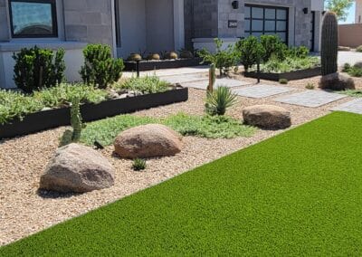 Modern front yard landscape in Scottsdale, AZ with clean lines, desert plants, and architectural lighting by Eclipse Landscape & Design.